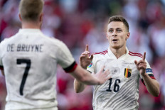 Belgium's midfielder Thorgan Hazard (right) celebrates with Belgium's midfielder Kevin De Bruyne after scoring the team's first goal during the UEFA EURO 2020 Group B football match between Denmark and Belgium at the Parken Stadium in Copenhagen on June 17, 2021.
