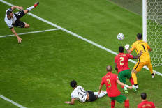 Germany's defender Robin Gosens (left) shoots and beats Portugal's goalkeeper Rui Patricio (right) but the goal is ruled out after a VAR review for offside during the UEFA EURO 2020 Group F football match between Portugal and Germany at Allianz Arena in Munich on June 19, 2021.
