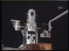 In this May 14, 2009 image taken from NASA video, astronaut John Grunsfeld (left) makes a repair during the first space walk to repair the Hubble space telescope. The two astronauts from the US space shuttle Atlantis Thursday began the first of five ambitious spacewalks to overhaul the Hubble and extend its working life. The spacewalk by astronauts John Grunsfeld and Drew Feustel got under way at 1252 GMT and was scheduled to last for six to seven hours. Grunsfeld and Feustel will also replace the telescope's failing science computer. The Science Instrument Command and Data Handling system experienced a partial electronic failure in late September. 