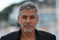 In this file photo taken on May 12, 2016 US actor George Clooney poses during a photocall for the film "Money Monster" at the 69th Cannes Film Festival in Cannes, southern France.