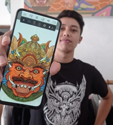 Futurist art: Dewa Gede Raka Jana Nuraga, aka Rakajana, poses with one of his digital art creations.