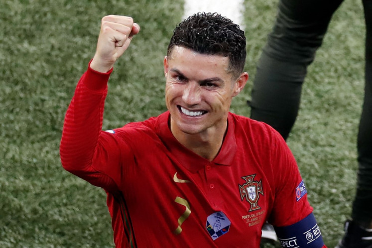 Portugal's forward Cristiano Ronaldo gestures towards the stands after the UEFA EURO 2020 Group F football match between Portugal and France at Puskas Arena in Budapest on June 23, 2021.
