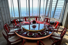 A table is seen in the restaurant of the J Hotel, the world's highest luxury hotel, boasting a restaurant on the 120th floor and 24-hour personal butler service, located in the Shanghai Tower, in Shanghai on June 23, 2021. 