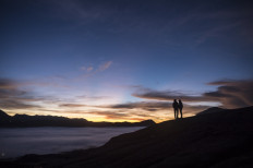 Tengger tribe people make their way to the summit of the active Mount Bromo volcano to make offerings in Probolinggo, East Java province on June 26, 2021, during the Yadnya Kasada festival to seek blessings from the main deity by presenting offerings of rice, fruit, livestock and other items.
