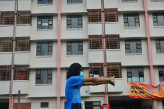 Survivor mode: A COVID-19 patient stretches before exercising at the Bakalankrapyak low-cost apartment block in Kudus, Central Java. The apartment building has been turned into a quarantine center for COVID-19 patients, whose numbers are soaring following the Idul Fitri holiday season. 