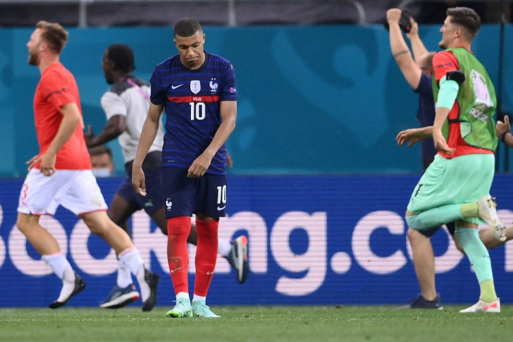 France's forward Kylian Mbappe reacts after missing the final penalty during the UEFA EURO 2020 round of 16 football match between France and Switzerland at the National Arena in Bucharest on June 28, 2021. 