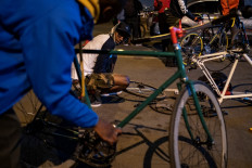 Members of the Biking Bandits prepare their bicycles as cyclists gather for the "Homies Night Ride" in Soweto on June 24, 2021. The Biking Bandits, a Soweto-based cycling crew, hosted a "Homies Night Ride," an evening cycling route through the streets of Soweto.