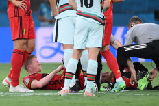 Belgium's midfielder Kevin De Bruyne lies on the pitch after resulting injured during the UEFA EURO 2020 round of 16 football match between Belgium and Portugal at La Cartuja Stadium in Seville on June 27, 2021. 