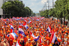 Dutch football supporters walk to the Ferenc Puskas Arena, as the Dutch team plays in the last sixteen Euro 2020 football match against the Czech Republic in Budapest, on June 27, 2021. About 7,000 to 10,000 Dutch people have traveled to the Hungarian capital to attend the football match.