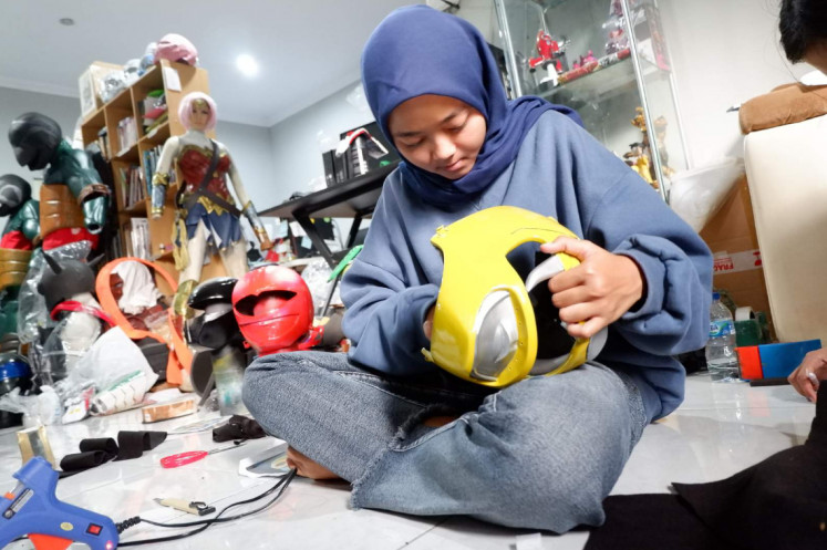Far-ranging orders: An intern at Yogyakarta-based PT. Jawara Tokoh Unggulan's costuming arm, JToku Studio, works on a Yellow Ranger helmet from the popular 'Power Ranger' series. The studio also receives orders from overseas, including the California-based creators of fan series 'Power Rangers: Shattered Past'.