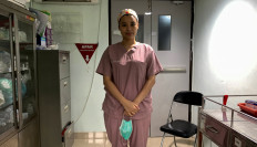 Cheras Sjarfi, a 28-year-old doctor, poses for pictures before her shift treating coronavirus disease (COVID-19) patients at a government-run hospital in Jakarta, Indonesia, July 1, 2021. Picture taken July 1, 2021. 
