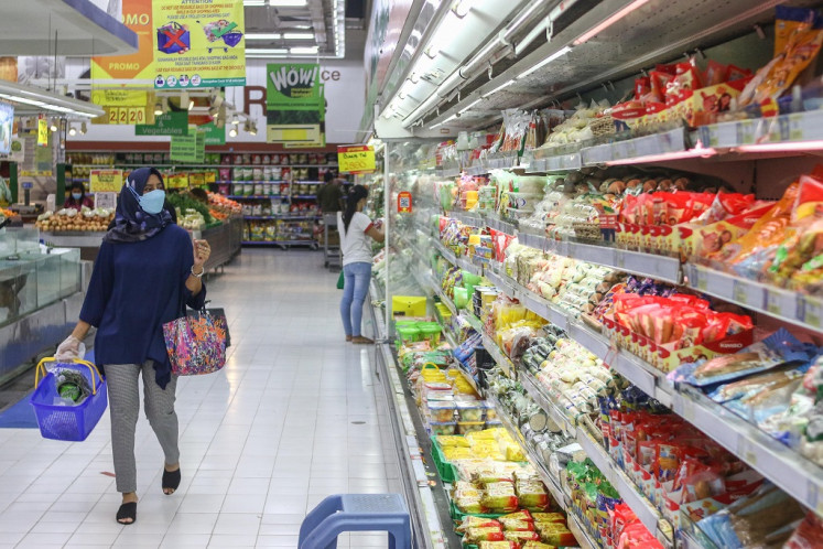 A customer broses for groceries in a supermarket in Jakarta on July 2, 2021. 