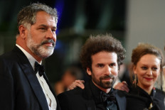 French writer and director Cyril Dion (C) arrives for the screening of the film "Sorry We Missed You" at the Cannes Film Festival in Cannes, southern France, on May 16, 2019. The French filmmaker and activist's new documentary "Animal" shows the threat to global biodiversity in the 2021 Cannes Film Festival.