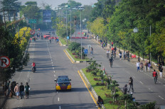Residents walk through the closed Jl. Al-Fathu in Soreang, Bandung regency, West Java on July 4, 2021. The Bandung regency administration closes several roads to limit public mobility during the emergency public activity restriction (PPKM Darurat) period from July 3 to 20.