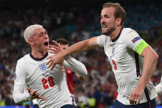 England's forward Harry Kane (R) celebrates with England's midfielder Phil Foden (L) after scoring a goal during the UEFA EURO 2020 semi-final football match between England and Denmark at Wembley Stadium in London on July 7, 2021.