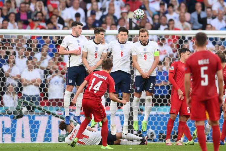 Denmark's forward Mikkel Damsgaard (C) shoots and scores during the UEFA EURO 2020 semi-final football match between England and Denmark at Wembley Stadium in London on July 7, 2021.
