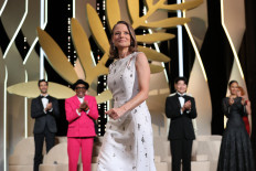 US actress and director Jodie Foster arrives on stage to receive a Palme d'Or Life Achievement Award during the opening ceremony of the 74th edition of the Cannes Film Festival in Cannes, southern France, on July 6, 2021.
