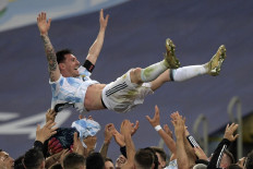 Argentina's Lionel Messi is thrown into the air by teammates after winning the Conmebol 2021 Copa America football tournament final match against Brazil at Maracana Stadium in Rio de Janeiro, Brazil, on July 10, 2021. Argentina won 1-0.
