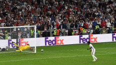 Italy's goalkeeper Gianluigi Donnarumma (left) saves the penalty of England's midfielder Bukayo Saka to win the UEFA EURO 2020 final football match between Italy and England at the Wembley Stadium in London on July 11, 2021.

