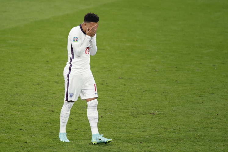 England's forward Jadon Sancho reacts after missing his penalty during the UEFA EURO 2020 final football match between Italy and England at the Wembley Stadium in London on July 11, 2021. 