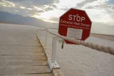A sign warns of extreme heat in Death Valley, California, US, July 11, 2021. 