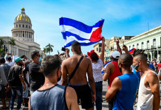 Cubans are seen outside Havana's Capitol during a demonstration against the government of Cuban President Miguel Diaz-Canel in Havana, on July 11, 2021. Thousands of Cubans took part in rare protests Sunday against the communist government, marching through a town chanting 