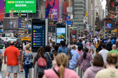 People walk through Times Square in New York City, United States, on July 13, 2021.