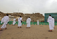 Mulism pilgrims pray on Saudi Arabia's Mount Arafat, also known as Jabal al-Rahma (Mount of Mercy), southeast of the holy city of Mecca, during the climax of the Hajj pilgrimage amid the COVID-19 pandemic, on July 19, 2021. Muslim pilgrims gathered at Saudi Arabia's Mount Arafat on Monday in the high point of this year's hajj, being held in downsized form and under coronavirus restrictions for the second year running. Just 60,000 people, all citizens or residents of Saudi Arabia, have been selected to take part in this year's hajj, with foreign pilgrims again barred.