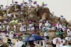 Muslim pilgrims gather around Mount Arafat, also known as Jabal al-Rahma (Mount of Mercy), southeast of the holy city of Mecca, Saudi Arabia, during the climax of the haj pilgrimage amid the COVID-19 pandemic, on July 19, 2021. 