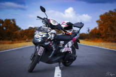 Surrounded by friends: Yoga's motorcycle is decorated with his favorite anime characters.