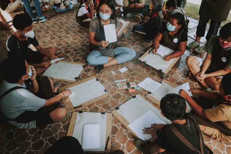 Creative kids: Irene Febry co-facilitates a collage workshop with children from Desa Ole, Tabanan, Central Bali as a part of CushCush Galleries 'Tell me Tales' ‘Charcoal for Children’ workshop programs.