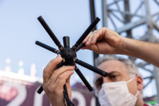 Nuno Duarte, a senior audio manager at Olympic Broadcasting Services, shows a microphone that collects immersive sound at the Aomi Urban Sports Park, the main venue for 3x3 basketball, during the Tokyo 2020 Olympic games, in Tokyo on July 19, 2021.