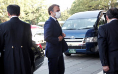French President Emmanuel Macron (center) arrives at the Imperial Palace for a meeting with Japan's Emperor Naruhito in Tokyo on July 23, 2021, ahead of the opening ceremony for the 2020 Tokyo Olympic Games. 