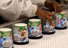 A labourer works on a production line filling ice-cream pots at the Ben & Jerry's factory in Be'er Tuvia in southern Israel, on July 21, 2021. Ben & Jerry's announced that it will stop selling ice cream in the Israel-occupied Palestinian territories since it was "inconsistent with our values", although it said it planned to keep selling its products in Israel.