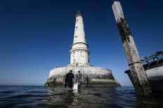 Lighthouse keeper Thomas Dalisso (R) and his colleague Nicolas Quezel-Guerraz are leaving the Cordouan lighthouse off the coast of Le Verdon-sur-Mer, southwestern France on June 11, 2021. The lighthouse will be added to UNESCO's World Heritage List.