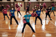 Members of the Japanese senior cheerleading squad 'Japan Pom Pom' take part in a practice in Tokyo on July 26, 2021, as the city hosts the 2020 Tokyo Olympic Games. Founder Fumie Takino has spearheaded the group of bubbly seniors since 1996, founding the 'Japan Pom-Pom' squad after being bitten by the cheerleading bug -- despite it traditionally being the preserve of teenage girls -- in her sixties.