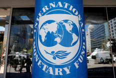The International Monetary Fund logo is seen outside its headquarters during the IMF/World Bank spring meetings in Washington, DC, in April 2018.