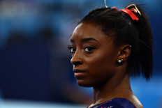 USA's Simone Biles gets ready to compete in the uneven bars event of the artistic gymnastics women's qualification during the Tokyo 2020 Olympic Games at the Ariake Gymnastics Centre in Tokyo on July 25, 2021.
