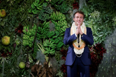 France's President Emmanuel Macron gestures after delivering a speech prior to his departure on the final day of his visit in Papeete, French Polynesia on July 27, 2021. 