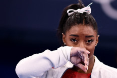  In this file photo taken on July 27, 2021 USA's Simone Biles gestures during the artistic gymnastics women's team final during the Tokyo 2020 Olympic Games at the Ariake Gymnastics Centre in Tokyo. Simone Biles withdrew from Olympics all-around gymnastics on July 28, 2021.