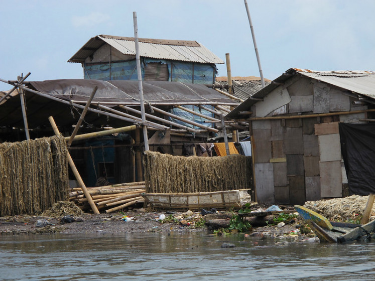 Low-income households on Jakarta riverbanks, such as these photographed on Jan. 17, 2011, are at high risk of flooding.