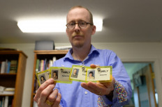 'Families of Flight 93' president Gordon Felt, 57, who lost his brother Edward Felt on Flight 93 during the September 11, 2001 attacks holds up his family visitor passes used to get access to the cash site in Shanksville, Pennsylvania on May 26, 2021 in New York City.