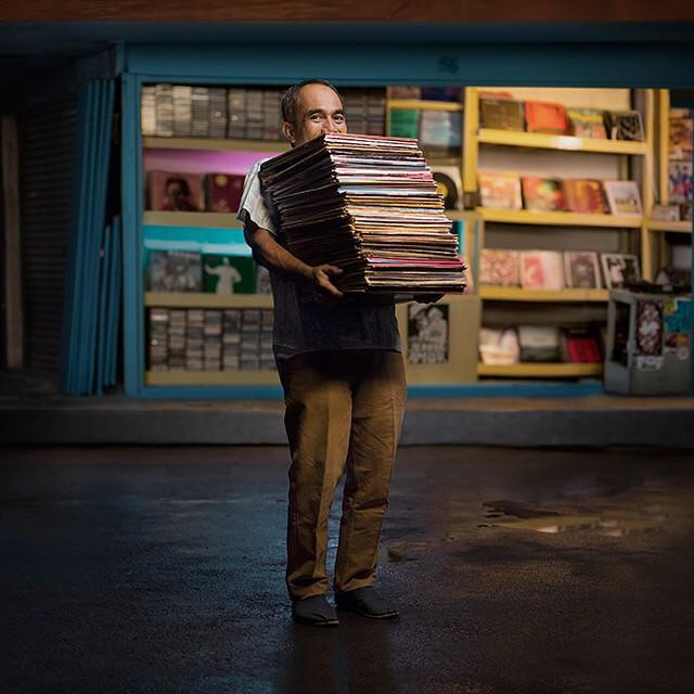 Piles of records: Lian tending his store. 