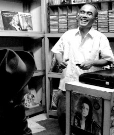 Happy place: Lian laughs among his record collection.
