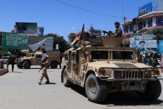 In this file photo Afghan security forces sit in a Humvee vehicle amid ongoing fighting between Taliban militants and Afghan security forces in Kunduz on May 19, 2020.