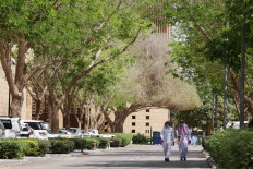 In this file photo taken on March 29, 2021 People walk on a tree-lined lane in the Saudi capital Riyadh.