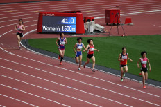 Athletes compete in a heat of the women's 1500m T20 category during a para-athletics test event for the 2020 Tokyo Olympics at the National Stadium in Tokyo on May 11, 2021. 