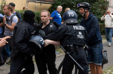 German police arrest a participant of an anti-lockdown protest in Berlin on August 1, 2021.