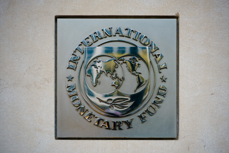 The seal of the International Monetary Fund (IMF) is seen on the financial institution's headquarters building in Washington, DC, on April 7, 2021.