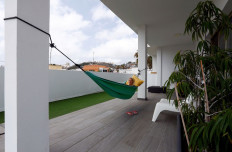 Olga Paul, a 34-year-old from Germany works remotely from Las Palmas De Gran Canaria, relaxes in hammock, amid the coronavirus disease (COVID-19) outbreak, in Gran Canaria, Spain July 23, 2021. Picture taken July 23, 2021. 